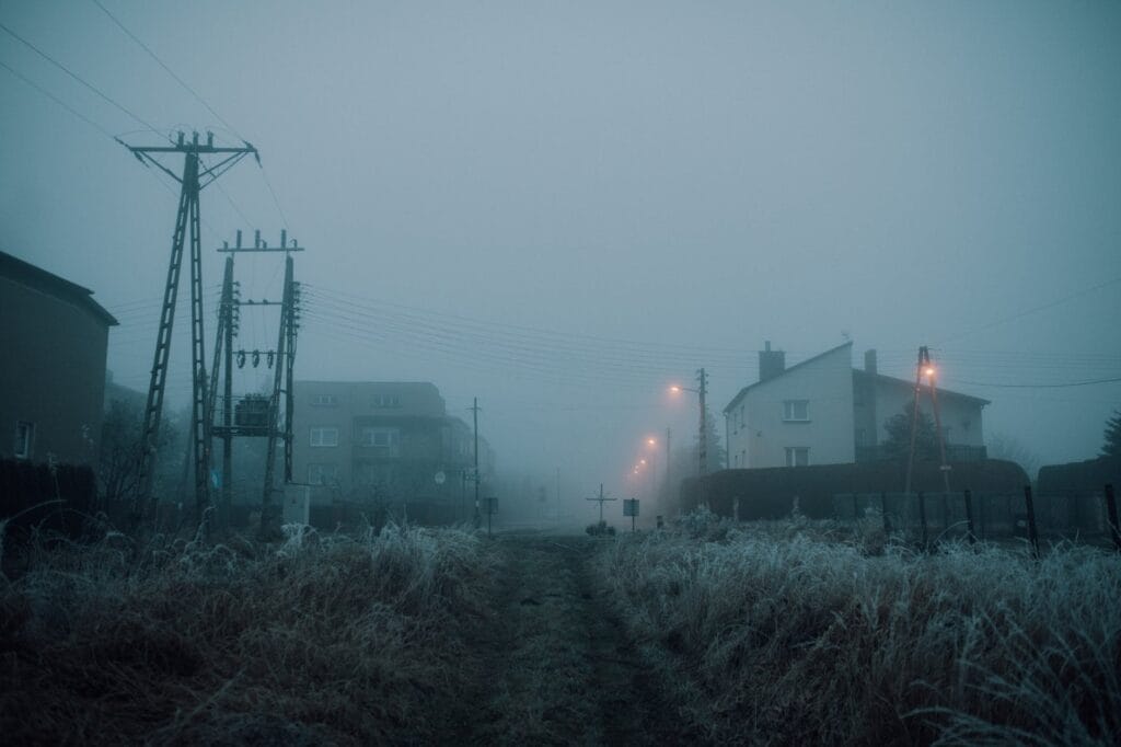 grass field near concrete buildings